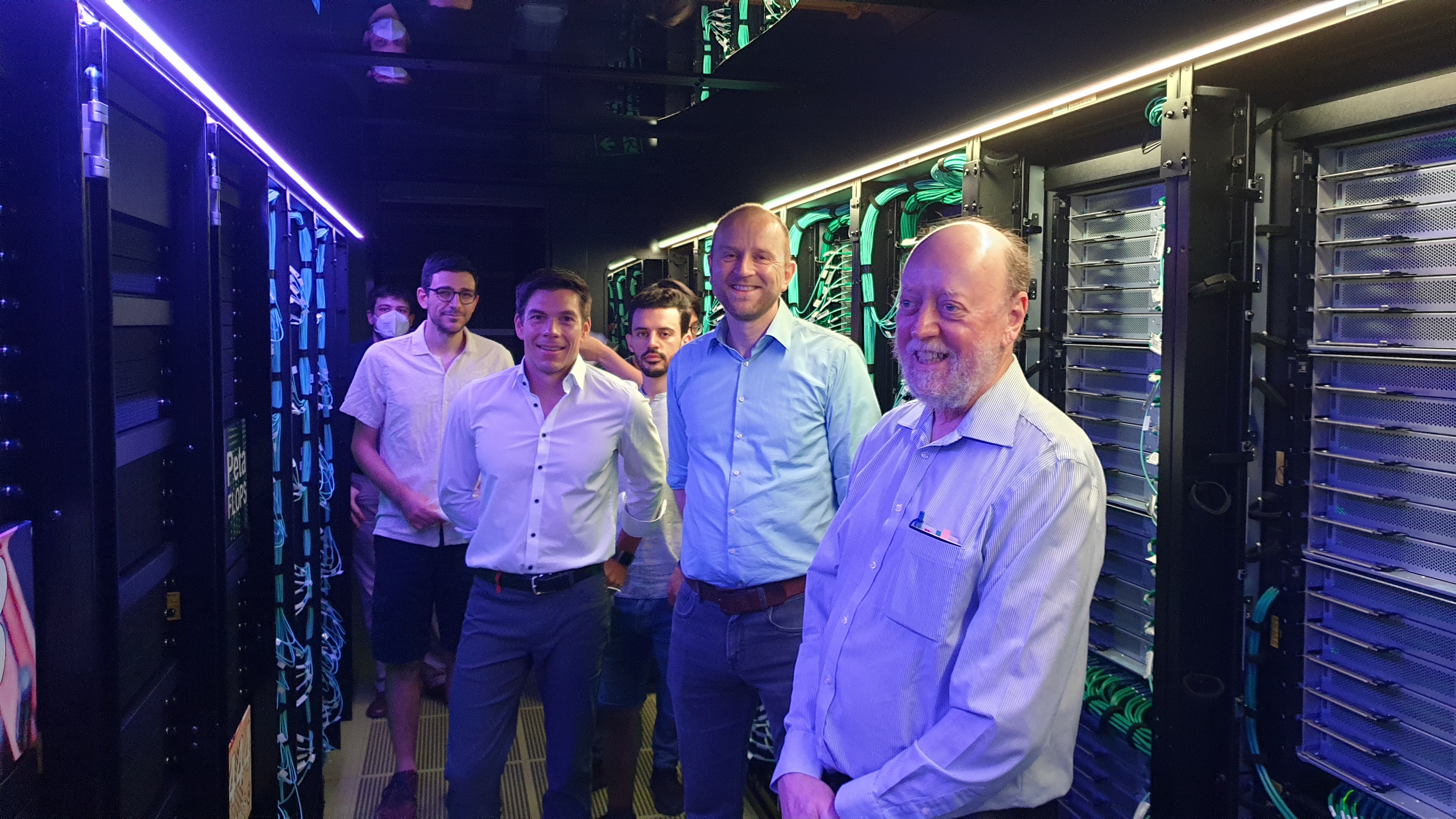 Hartwig Anzt, Martin Frank, and Jack Dongarra between the racks of
	  the HoreKa supercomputer at KIT